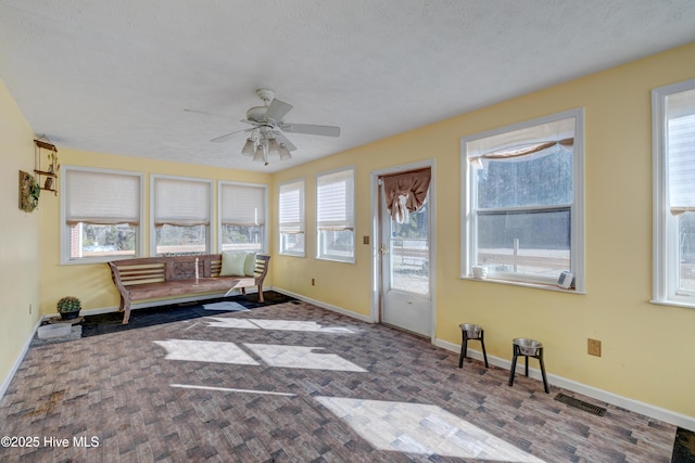 interior space with ceiling fan