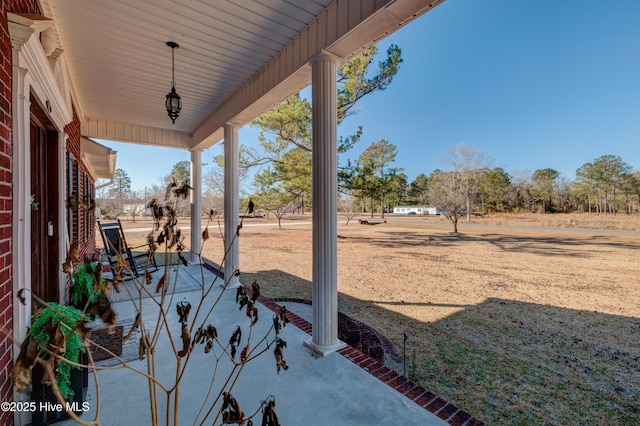 view of yard featuring covered porch