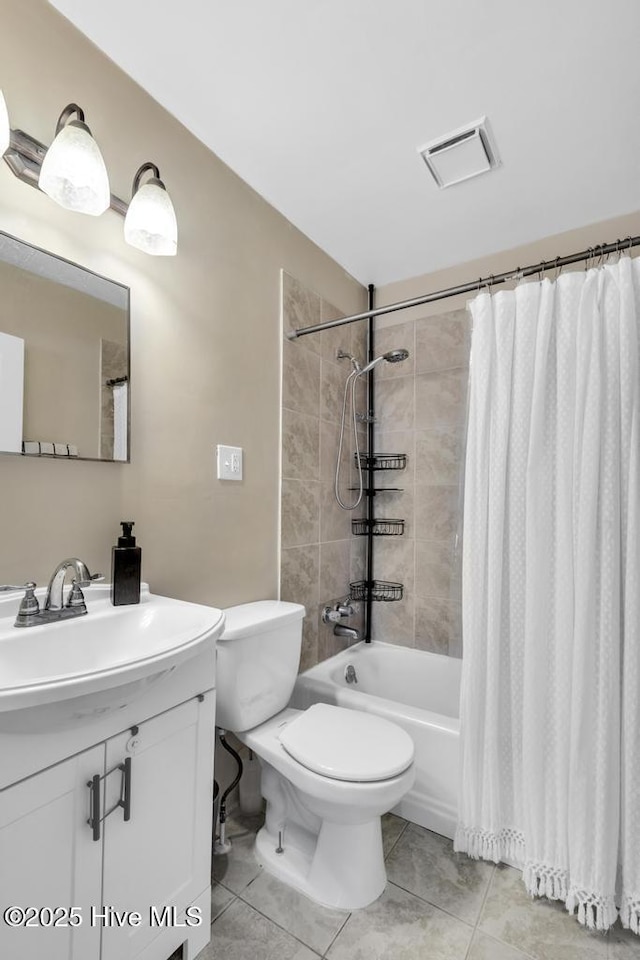 full bathroom featuring tile patterned floors, vanity, toilet, and shower / bath combo with shower curtain