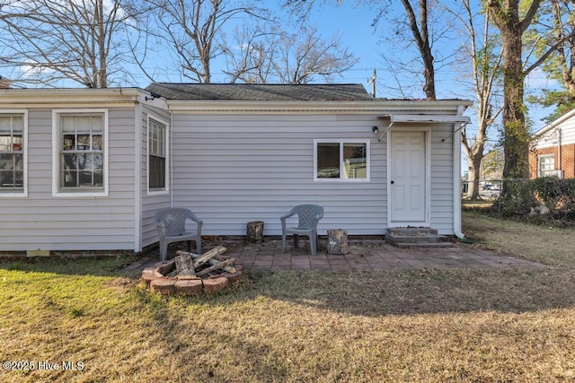 back of property featuring a lawn and a patio area