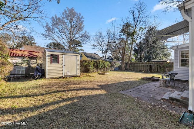 view of yard featuring a storage shed and a patio area