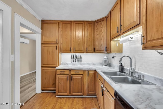 kitchen with sink, tasteful backsplash, a wall mounted air conditioner, ornamental molding, and light hardwood / wood-style floors