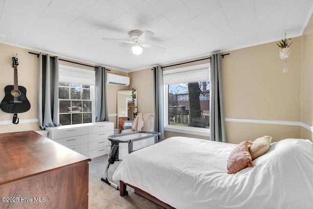 carpeted bedroom featuring crown molding, ceiling fan, and a wall unit AC