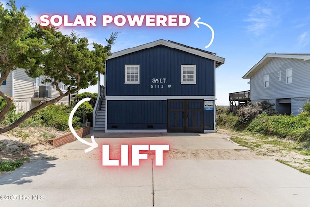 5113 W Beach Dr, Oak Island, NC 28465 - view of front of house with board and batten siding and cooling unit