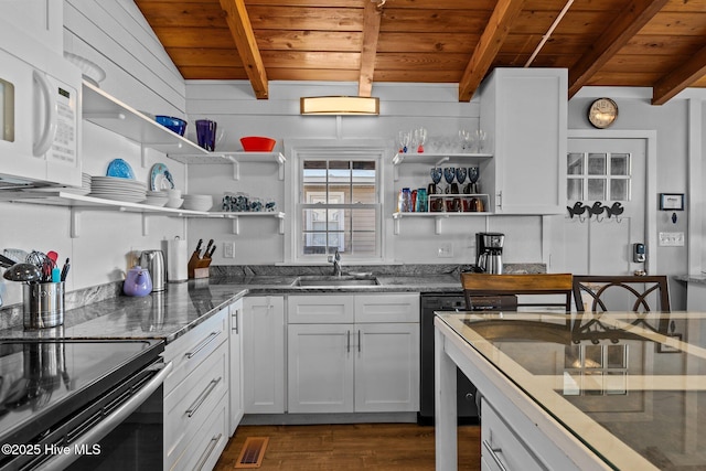 kitchen with black range with electric stovetop, wooden ceiling, beam ceiling, and white microwave