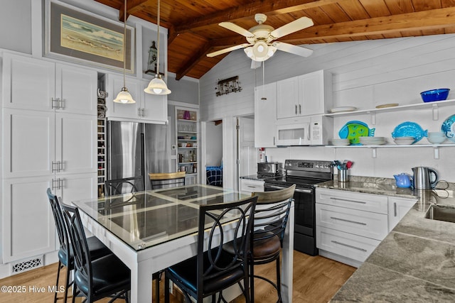 kitchen featuring white microwave, wood ceiling, open shelves, stainless steel fridge, and black electric range