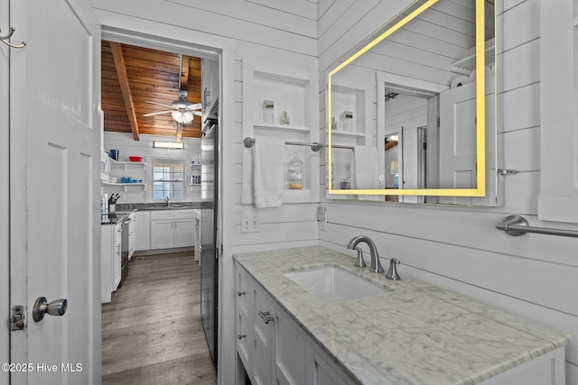 bathroom featuring wood ceiling, wooden walls, hardwood / wood-style flooring, ceiling fan, and beam ceiling