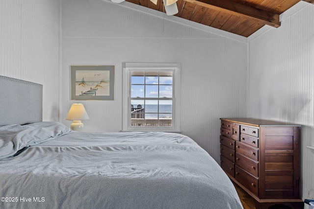 bedroom featuring a water view, wooden ceiling, and vaulted ceiling with beams