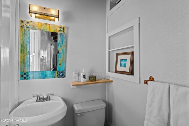 bathroom with toilet and a sink