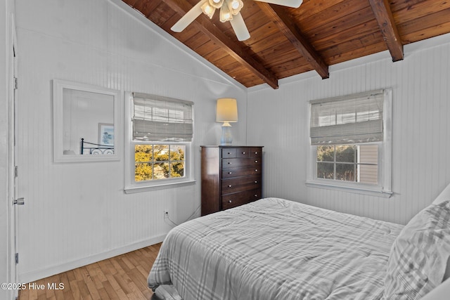 bedroom featuring wood ceiling, multiple windows, vaulted ceiling with beams, and wood-type flooring