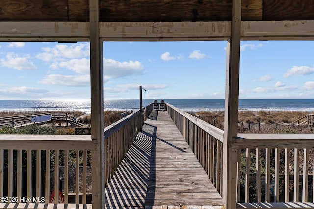 view of community with a water view and a beach view