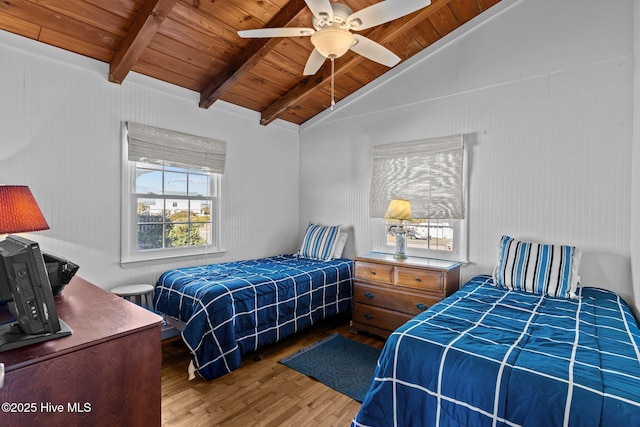 bedroom featuring wooden ceiling, wood finished floors, a ceiling fan, and lofted ceiling with beams