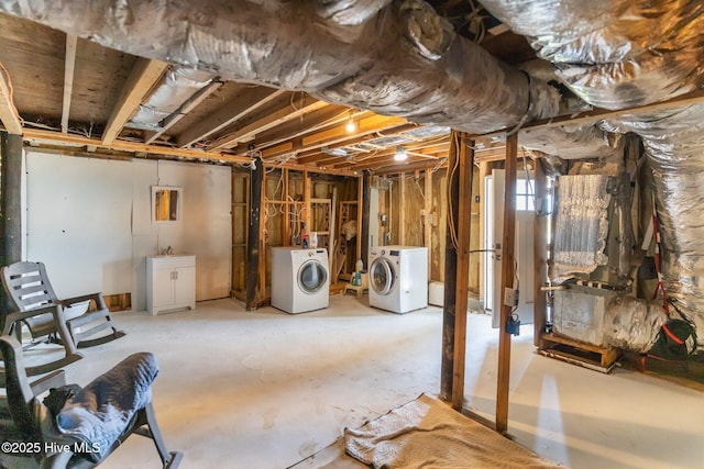 basement featuring washer and dryer and a sink