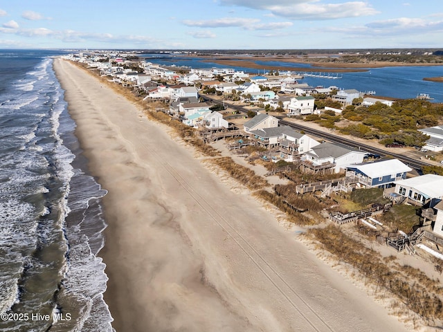 bird's eye view featuring a beach view and a water view