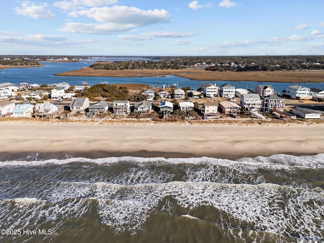 drone / aerial view with a view of the beach, a water view, and a residential view
