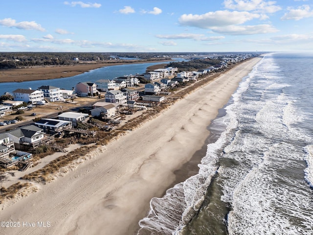 birds eye view of property with a beach view, a water view, and a residential view
