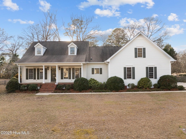 cape cod home featuring a front yard and a porch