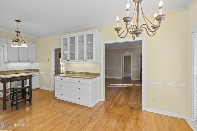 1985 Den Tree Ct, New Bern, NC 28562 - kitchen featuring ornamental molding, a notable chandelier, white cabinetry, and light wood finished floors