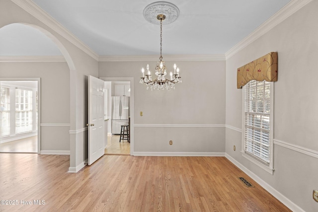 1985 Den Tree Ct, New Bern, NC 28562 - unfurnished dining area featuring crown molding, a chandelier, arched walkways, visible vents, and light wood-style floors
