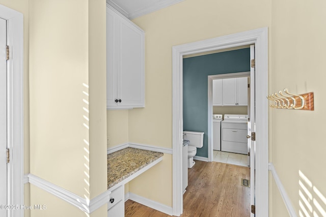 1985 Den Tree Ct, New Bern, NC 28562 - laundry room featuring washing machine and clothes dryer, cabinet space, visible vents, and light wood-style floors