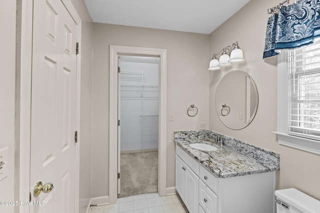 1985 Den Tree Ct, New Bern, NC 28562 - bathroom with baseboards, toilet, vanity, and a healthy amount of sunlight