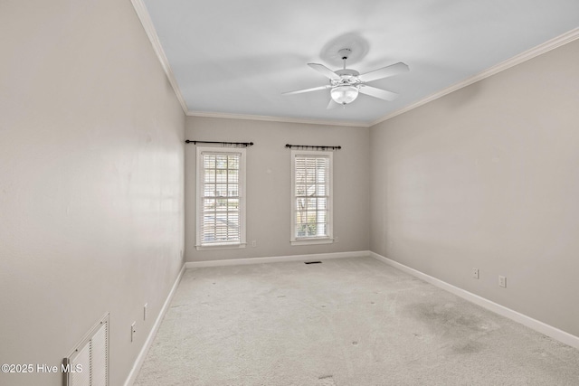 carpeted spare room featuring ceiling fan and ornamental molding