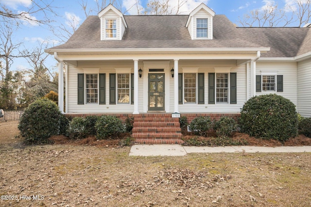 new england style home with covered porch