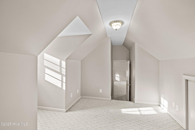 additional living space featuring light carpet and lofted ceiling