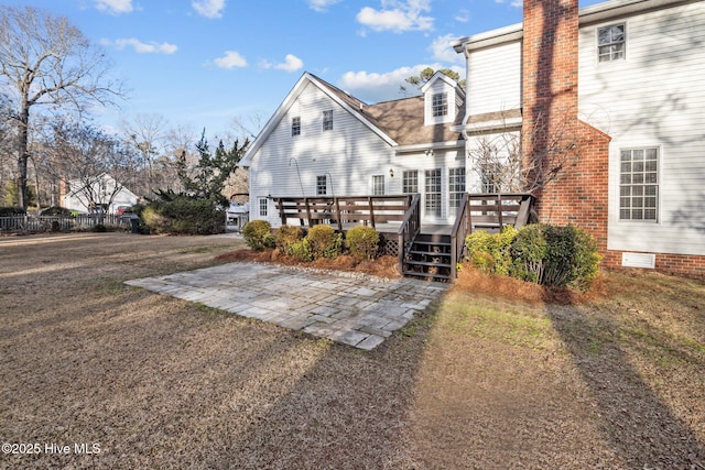 1985 Den Tree Ct, New Bern, NC 28562 - rear view of property with fence, a chimney, a wooden deck, and a patio