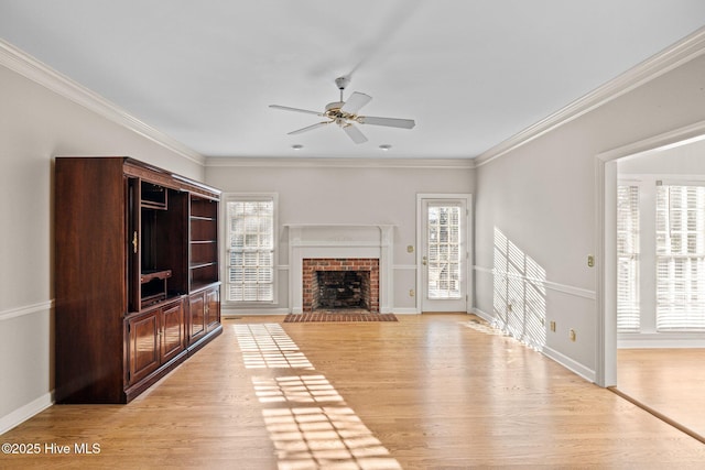 1985 Den Tree Ct, New Bern, NC 28562 - unfurnished living room featuring a brick fireplace, light wood-type flooring, ornamental molding, baseboards, and a ceiling fan