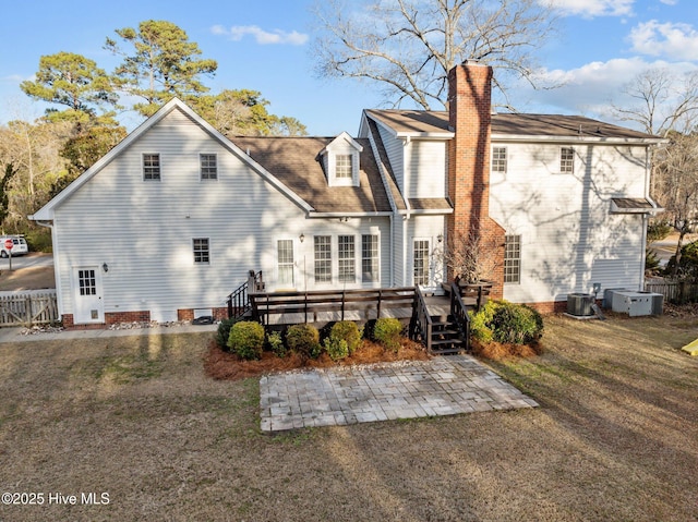 back of house featuring cooling unit, a yard, a patio area, and a deck