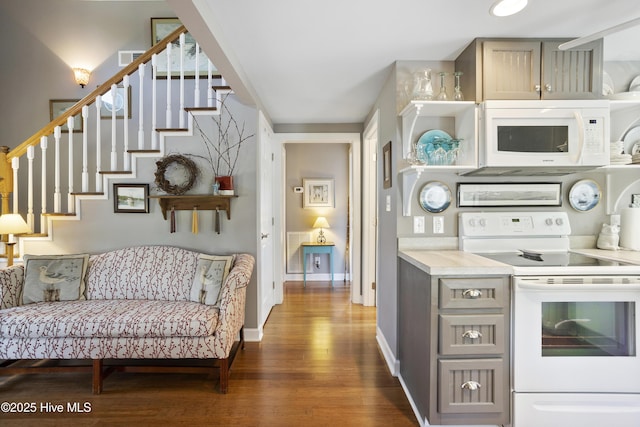 kitchen with white appliances, dark hardwood / wood-style floors, and gray cabinetry