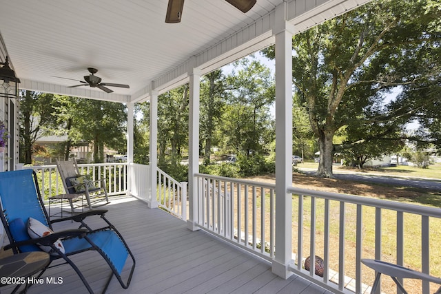 wooden terrace featuring a porch and ceiling fan