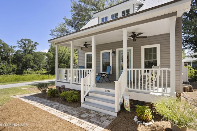 view of exterior entry with a porch and ceiling fan