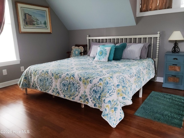 bedroom with dark hardwood / wood-style flooring and vaulted ceiling