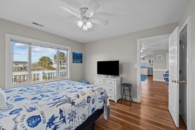 bedroom with ceiling fan and dark wood-type flooring