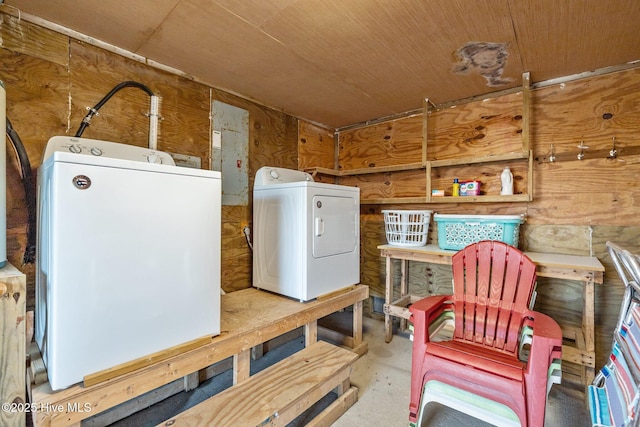 interior space with washing machine and dryer, wooden walls, and wooden ceiling