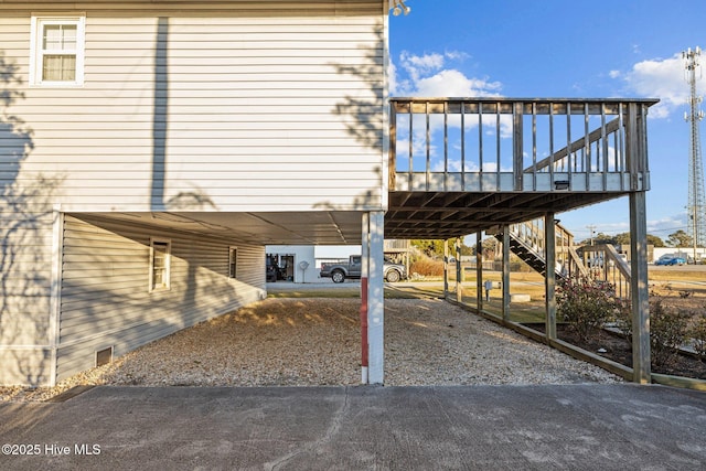 view of side of property featuring a wooden deck and a carport