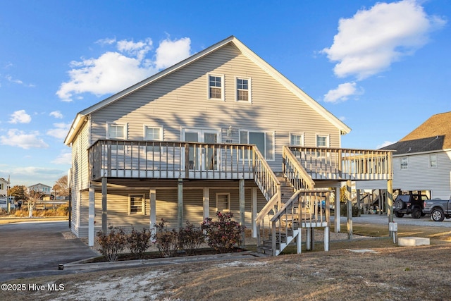 back of house with a deck