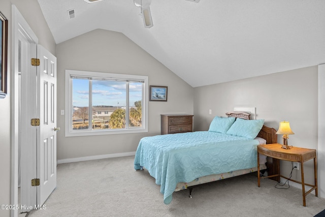 bedroom with ceiling fan, light carpet, and lofted ceiling