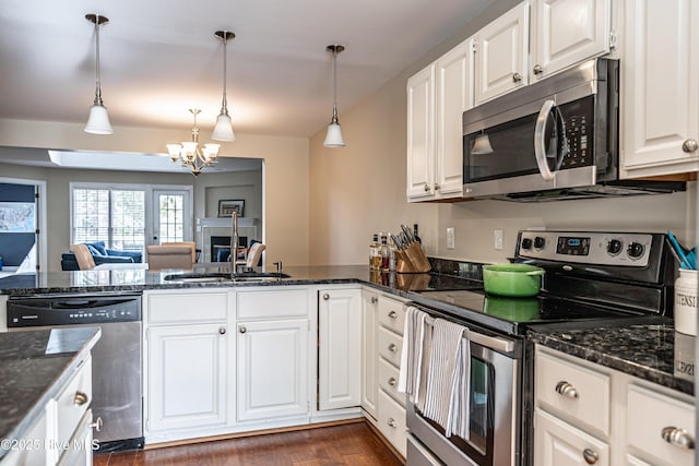 kitchen with white cabinets, pendant lighting, and appliances with stainless steel finishes