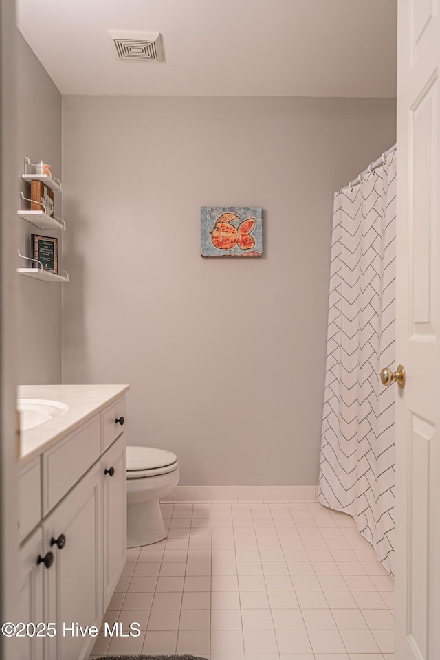 bathroom with toilet, vanity, tile patterned floors, and a shower with curtain