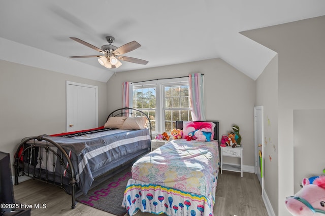 bedroom featuring ceiling fan, hardwood / wood-style floors, and lofted ceiling