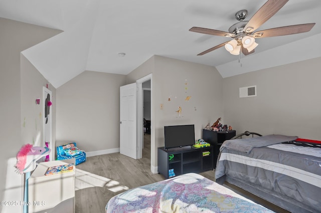 bedroom with ceiling fan, light hardwood / wood-style floors, and lofted ceiling