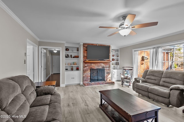 living room with built in features, ceiling fan, and ornamental molding