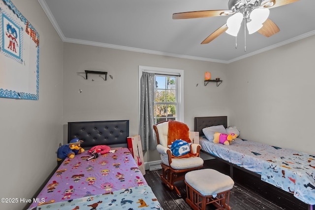 bedroom featuring dark wood-type flooring, ceiling fan, and ornamental molding