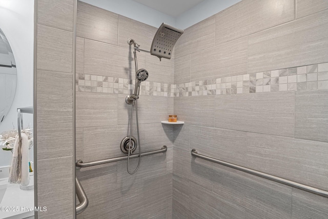 bathroom with tiled shower