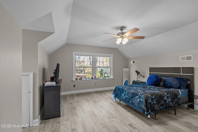 bedroom with ceiling fan, light hardwood / wood-style flooring, and lofted ceiling