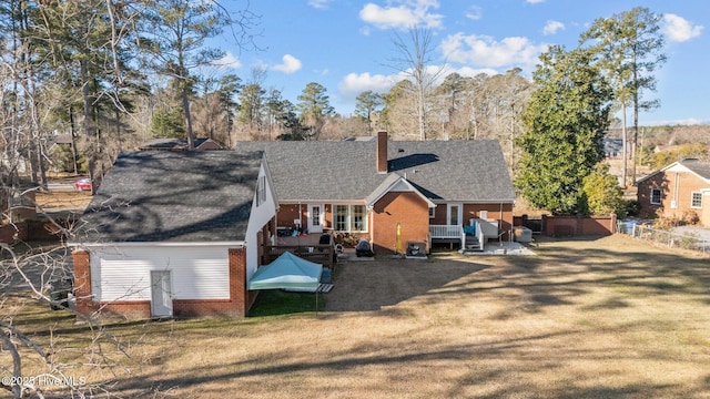 back of house with a patio area and a yard