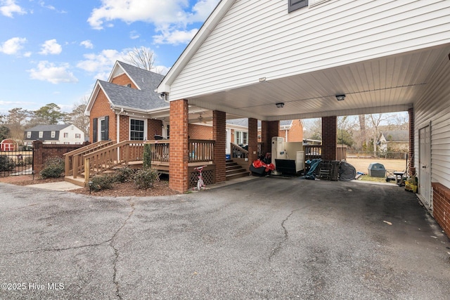 view of side of property with a wooden deck and a carport